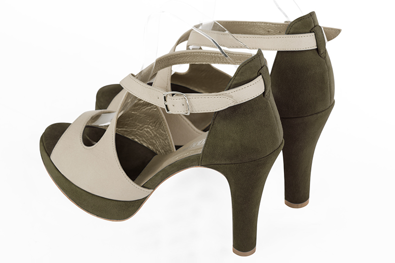 Off white and khaki green women's closed back sandals, with crossed straps. Round toe. Very high slim heel with a platform at the front. Rear view - Florence KOOIJMAN